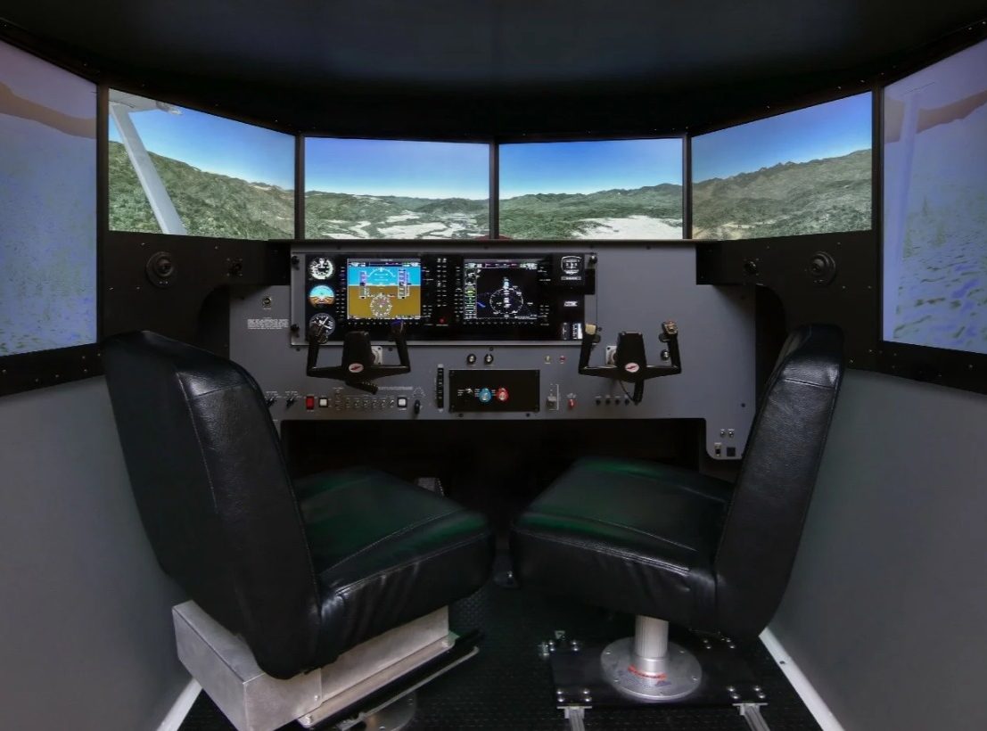 The two-seat Redbird MCX cockpit with its wrap-around visual screens