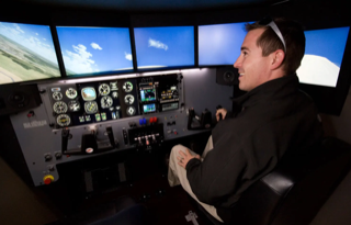 A student training in the FMX flight simulator